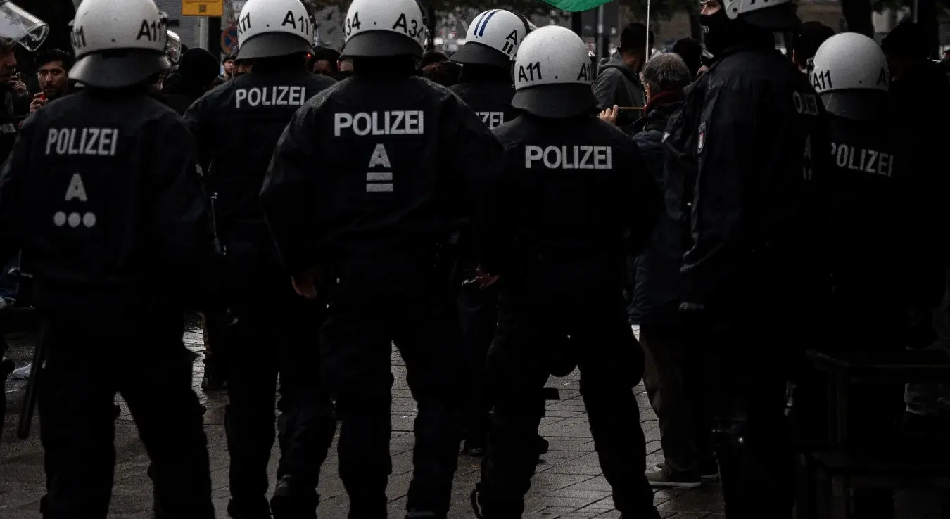 Полицајци у униформи чувају стражу током уличног протеста у Хамбургу у Немачкој.